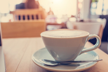 Cup of coffe on workplace desk, coffee shop.