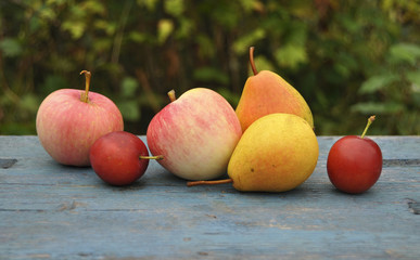 Ripe fruit on table close up. Background, apples, pears, plums, texture