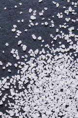 Fototapeta premium Large crystals of sea salt on a black background