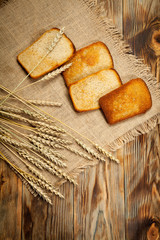 Toast bread in a wicker plate on wooden background. Top view