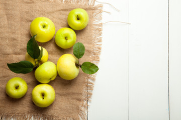 Fresh apples on a white wooden background