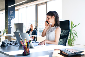 Two business women in the office working.