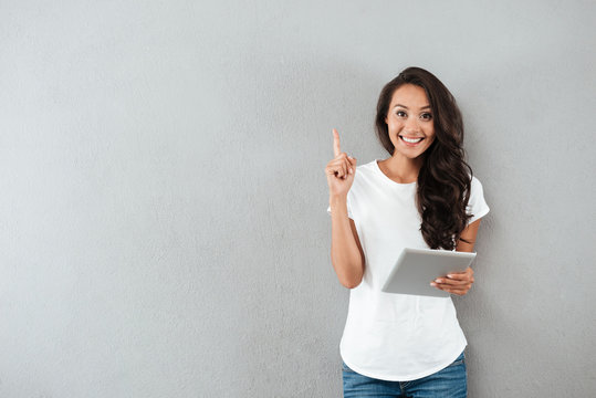 Excited Happy Asian Woman Holding Tablet Computer