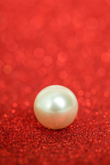 Pile of pearls on red christmas background