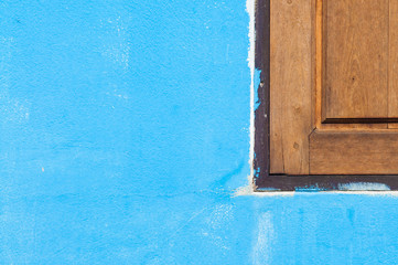 Wooden window on blue wall.