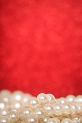 Pile of pearls on red christmas background