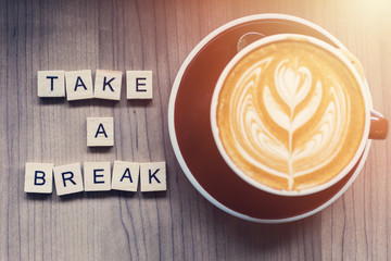 Cup of coffee on workplace desk, take a breake.