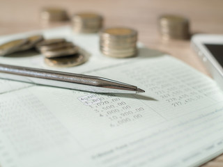 Saving Account Book from Bank for Business Finance with pen,  Smartphone and coin