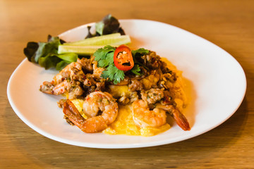 Spicy fried rice with shrimp and egg on white dish
