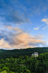 Fototapeta na wymiar Beautiful sunset view of church in Murau in Tirol, Austria, Europe