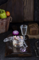 Marinated herring in a jar with onion