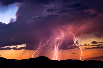 Deurstickers Onweer Bliksemschichten slaan in bij een storm bij zonsondergang