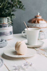 coffee and marshmallows on wooden background composition with flowers