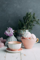 coffee and marshmallows on wooden background composition with flowers