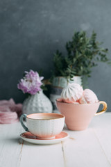 coffee and marshmallows on wooden background composition with flowers