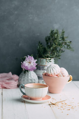 coffee and marshmallows on wooden background composition with flowers