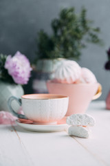 coffee and marshmallows on wooden background composition with flowers