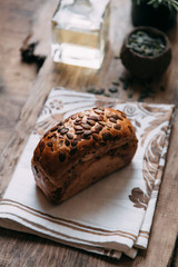 Sliced bread with butter on wooden background and the scattered seeds.