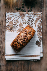 Sliced bread with butter on wooden background and the scattered seeds.