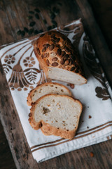 Sliced bread with butter on wooden background and the scattered seeds.