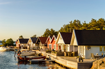 Fototapeta premium Houses along the small harbor in Norway. Sunset mood