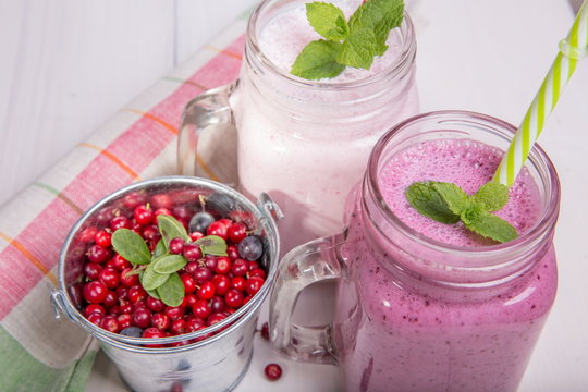 Assorted fruit or berry shakes on white table. Smoothie concept