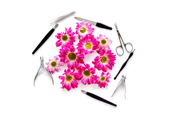 Hand care. Set of manicure tools and flowers on white background top view copyspace