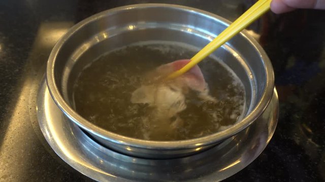 Close up of delicious thai food soup cooking hot and spicy with hand pock vegetable seafood and meat in restaurant. 4k uhd