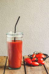tomato juice in a glass with a lid and a tube