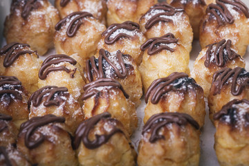Chocolate cream puff isolated on white background.