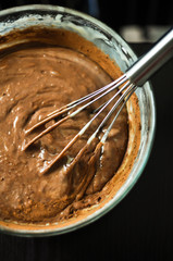 Dough for crepes or pancakes in glass bowl top view
