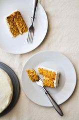 Top view of a homemade carrot cake white background. Cream cheese frosting.
