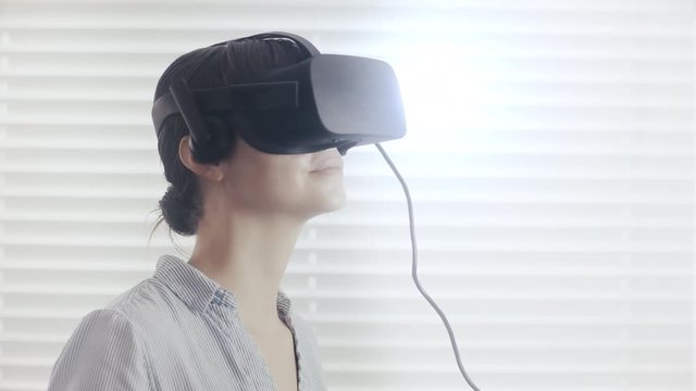 Beautiful businesswoman interacting in virtual reality. 4K UHD footage rendered at 16-bit color depth. (All logos and identifying marks removed in post.)