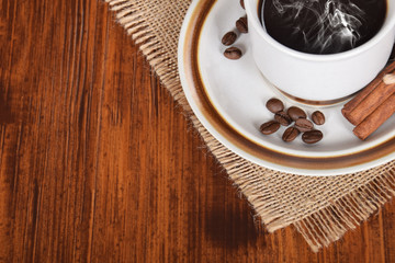 cup of hot black coffee and jug of milk