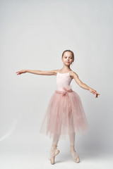 Fototapeta na wymiar little ballerina in a pink tutu dancing
