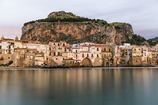 Beautiful harbor view of old houses in Cefalu at dusk, Sicily
