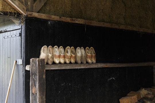Delden, The Netherlands. Traditional Dutch wooden shoes on a shelf in a barn.