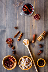 Merry christmas in winter evening with warm drink. Hot mulled wine or grog with fruits and spices on wooden background top view