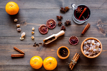 Hot mulled wine or grog cooking for new year celebration with oranges and spices ingredients on...