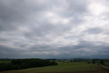 Obraz premium Beautiful rural landscape around Biei under a cloudy sky, Biei, Hokkaido, Japan