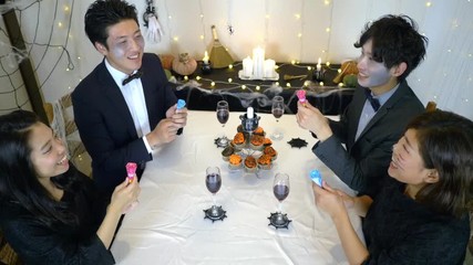 Halloween Dinner Party popping party poppers.