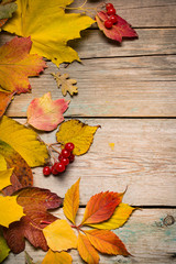 Naklejka na ściany i meble Autumn leaves on wooden boards