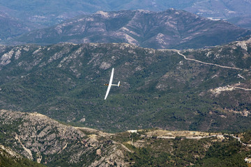 view of the sailplane flying over the mountains of Corsica
