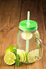 Detox water with lime slices in a glass jar.