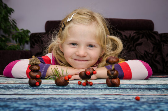 creative child with home made autumn craft