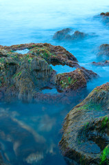 Fototapeta na wymiar Two stones on the seashore, shot on a long exposure.