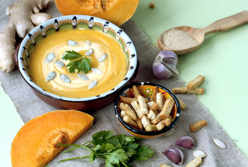 Pumpkin cream soup with crackers and ginger, parsley and  seeds