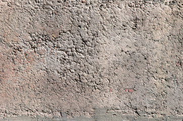A wall of cement crumbs of gray color.