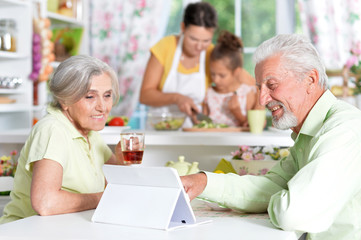 Senior couple looking at tablet