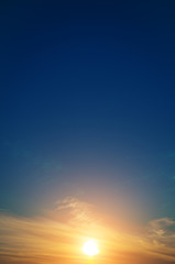 Dawn, the sun is in the sky and cirrus clouds.